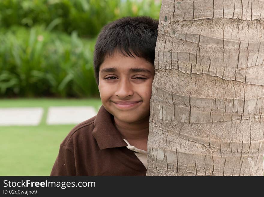 An handsome Indian kid peeping thru the trunk