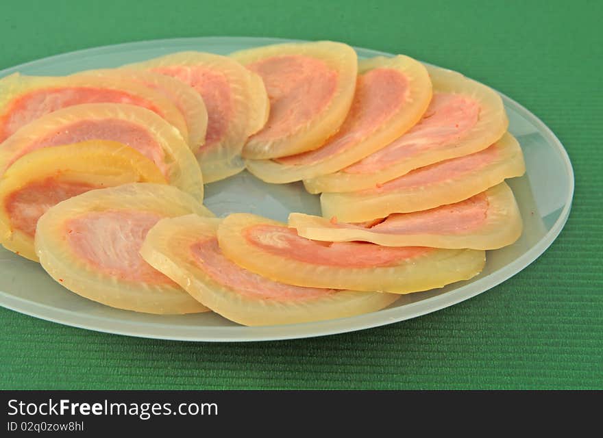 Small dish slice ham in green background