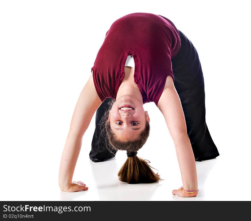 Front view of a happy preteen girl doing a backbend.  Isolated on white. Front view of a happy preteen girl doing a backbend.  Isolated on white.