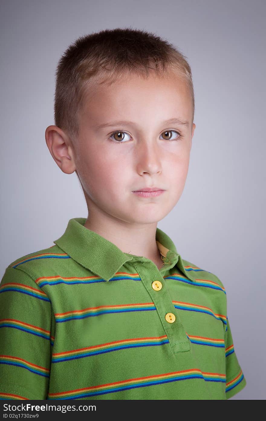 Young boy in green blouse with colorful stripes portrait. Young boy in green blouse with colorful stripes portrait