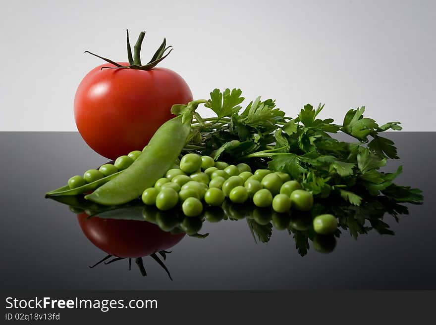 Fresh garden vegetables reflexion on black background