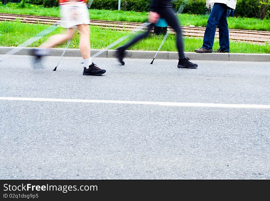 People on nordic walking race on city streets. People on nordic walking race on city streets