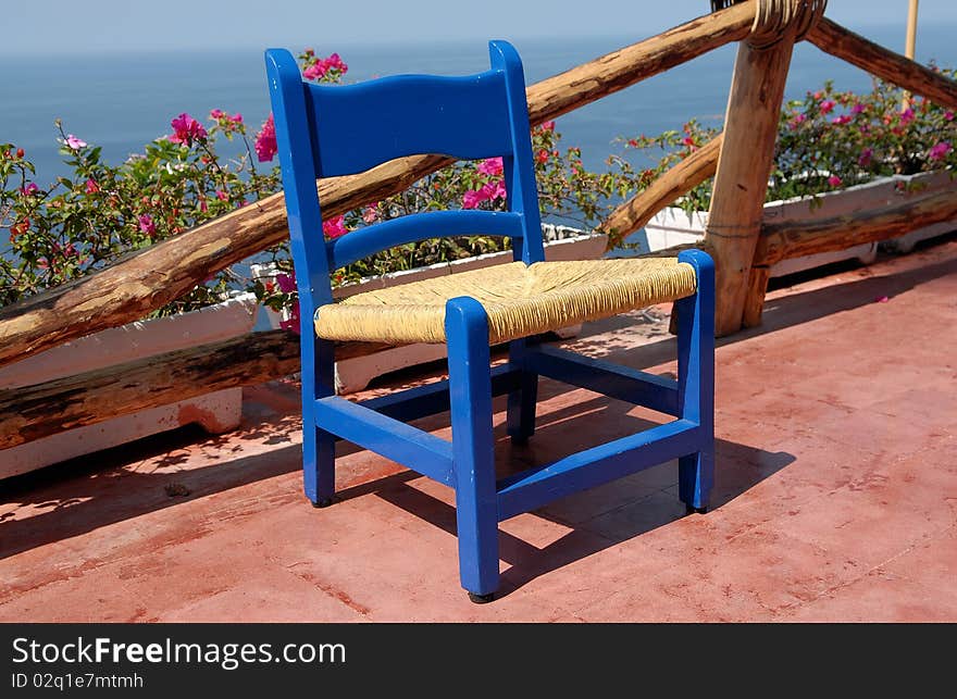 Teak patio chair on the beach