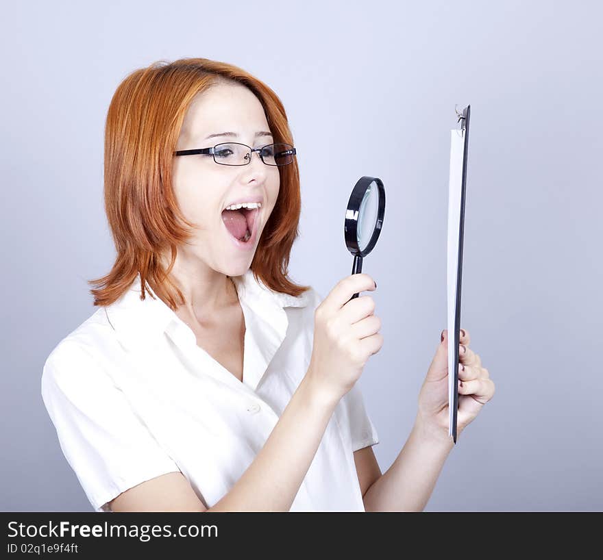 Young businesswomen with white plan board and loupe.