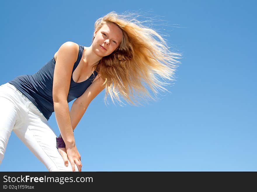 Lady with long hair in front of blue sky