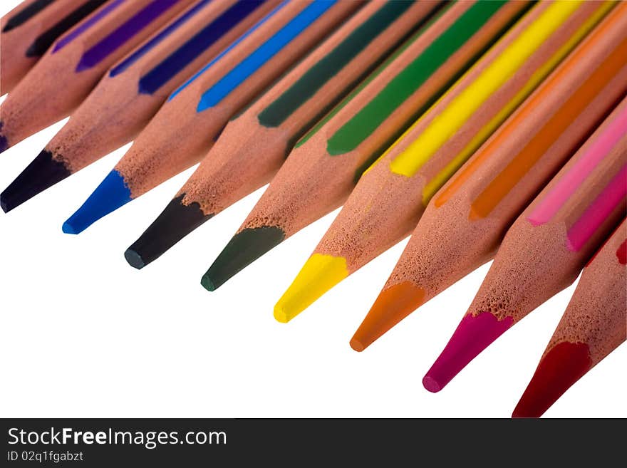 Coloured pencils in a line against white background