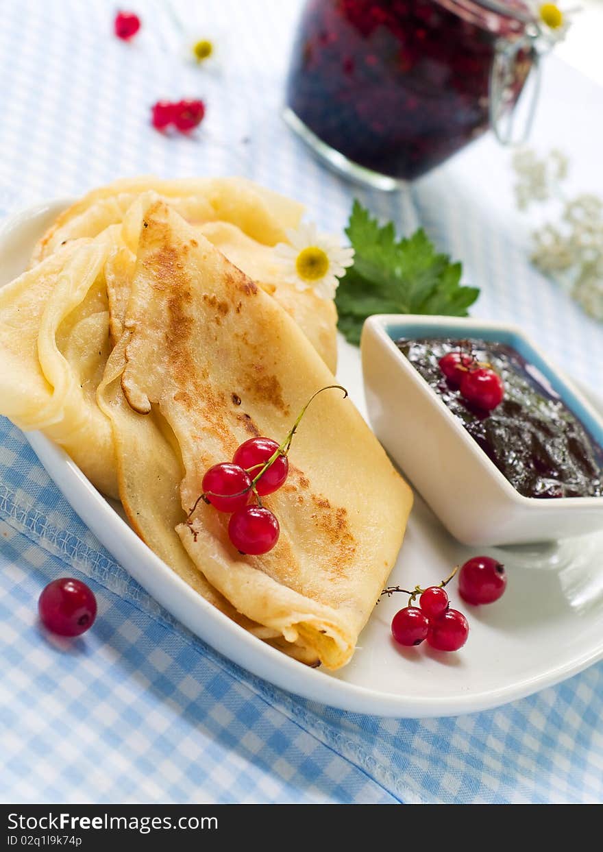 Pancakes with red currant jam for breakfast. Pancakes with red currant jam for breakfast