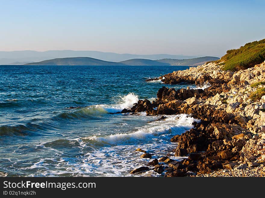 Beautiful view of the mountains and coast with rocks at Aegean Sea. Beautiful view of the mountains and coast with rocks at Aegean Sea