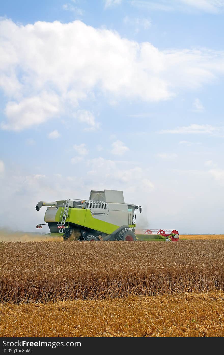 Modern combine harvester working on a wheat crop. Modern combine harvester working on a wheat crop