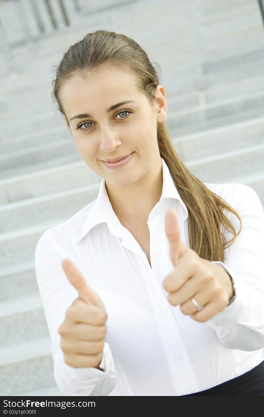 Young business woman shows a sign of OK. Young business woman shows a sign of OK.