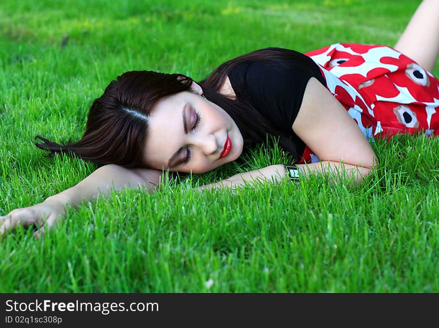 Beautiful woman relaxing on a meadow. Beautiful woman relaxing on a meadow.