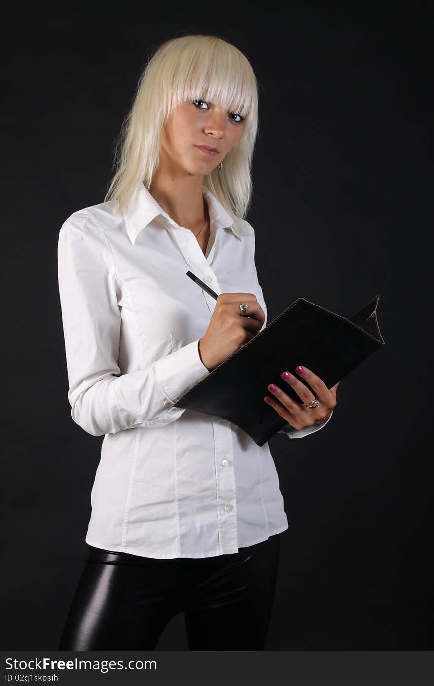 Beautiful business blonde lady looks at you with folder in hand