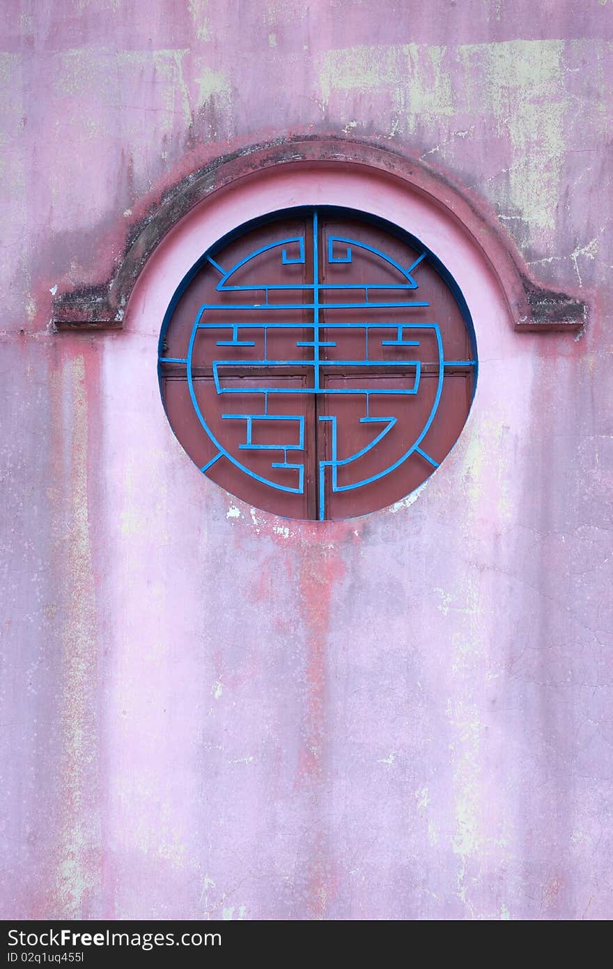 Circle chinese style window on the red wall ,vertical