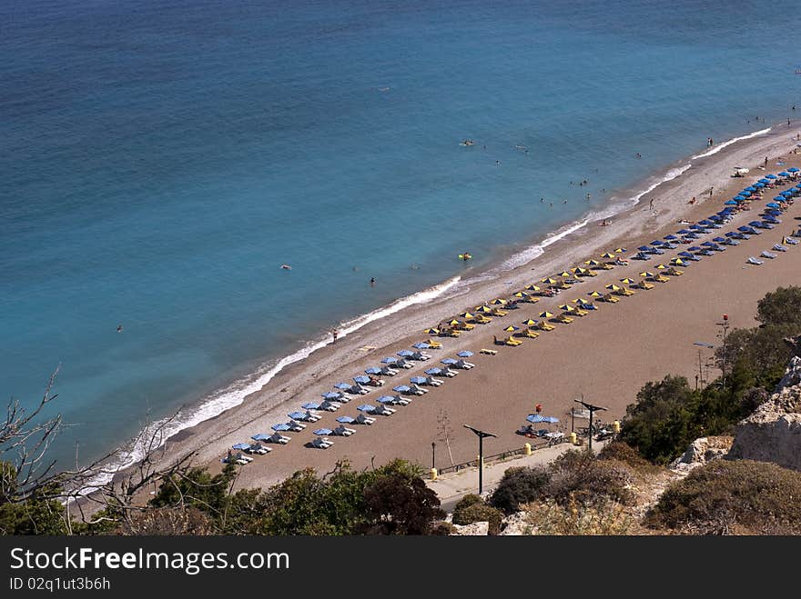 Beach in summer with parasols and beach chairs close to the sea. Beach in summer with parasols and beach chairs close to the sea.