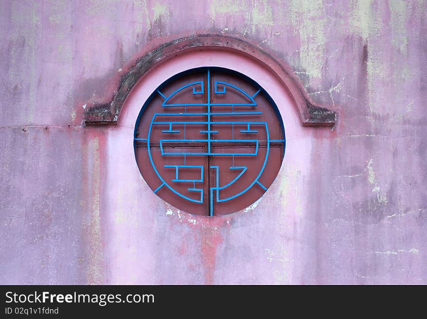 Circle chinese style window on the red wall ,vertical