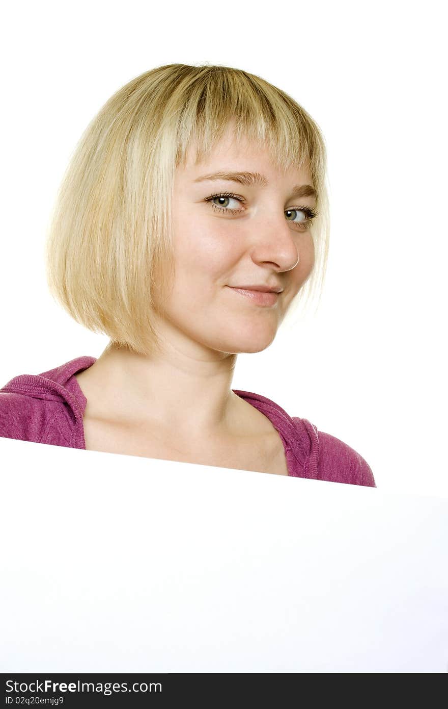 Young woman leaning on billboard