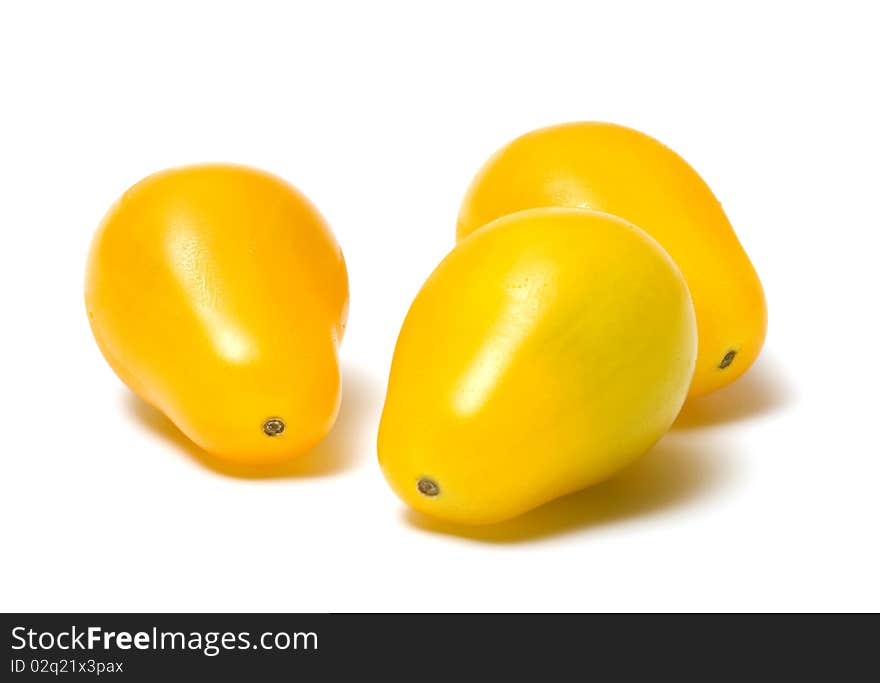 Three yellow tomato on a white background. Three yellow tomato on a white background.