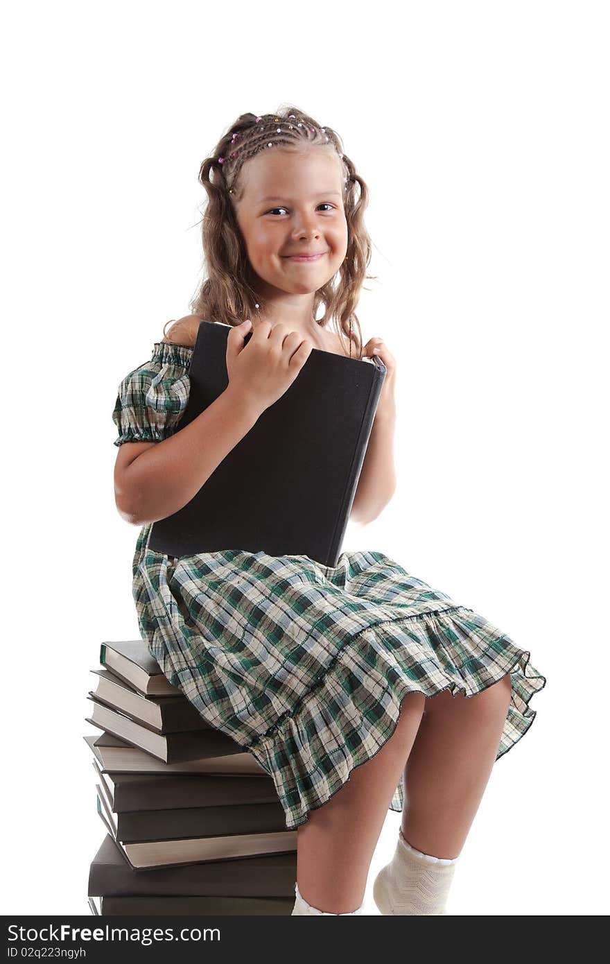 Little girl sitting on stacked books, isolated on white background