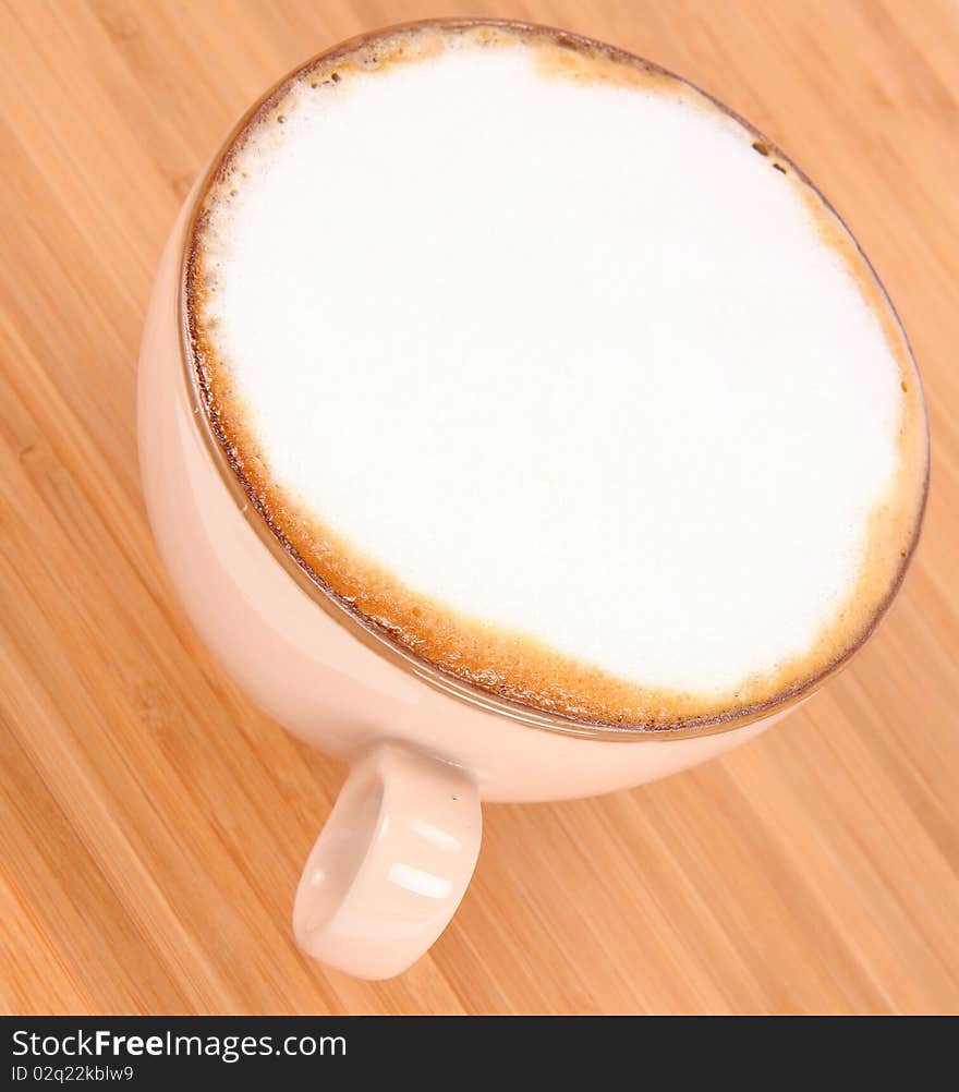 Cup of coffee latte on a wooden background