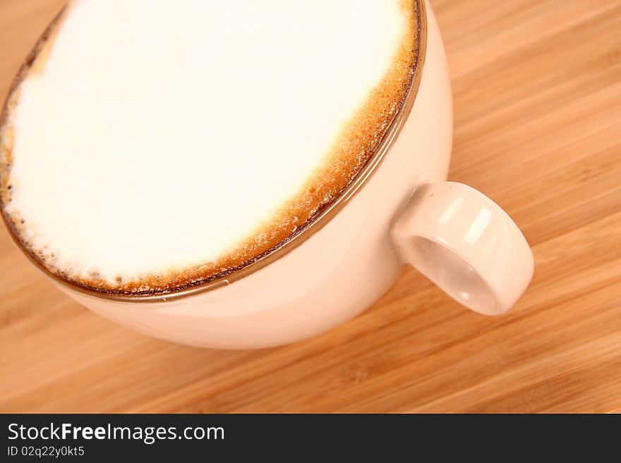 Cup of coffee latte on a wooden background