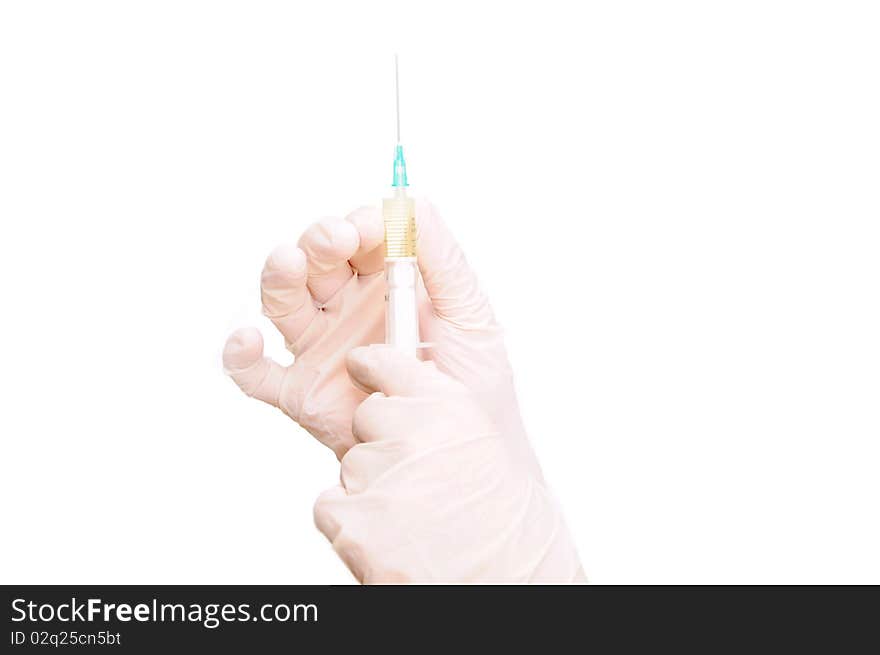 Hand in glove holding syringe and needle. Hand in glove holding syringe and needle