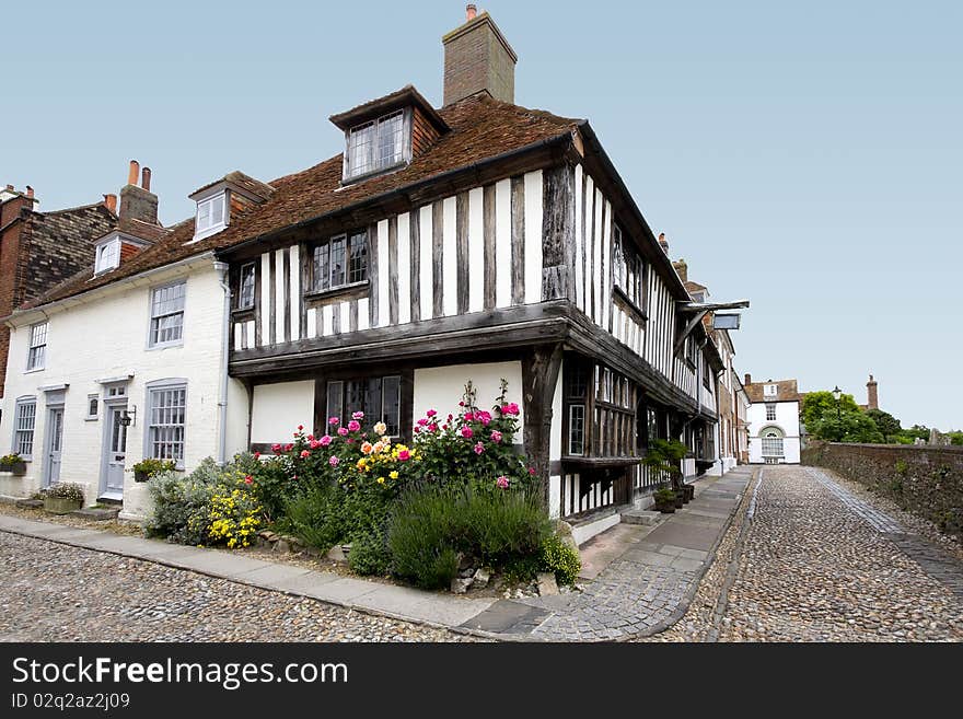 View of an old tudor house with a colourful flowerbed. View of an old tudor house with a colourful flowerbed