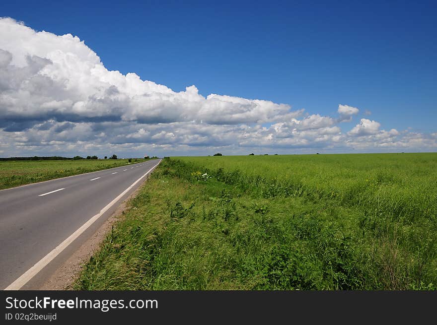 Empty road with clouds above