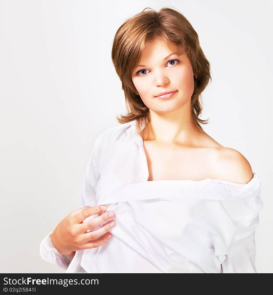 Portrait of a pretty young woman in a white shirt