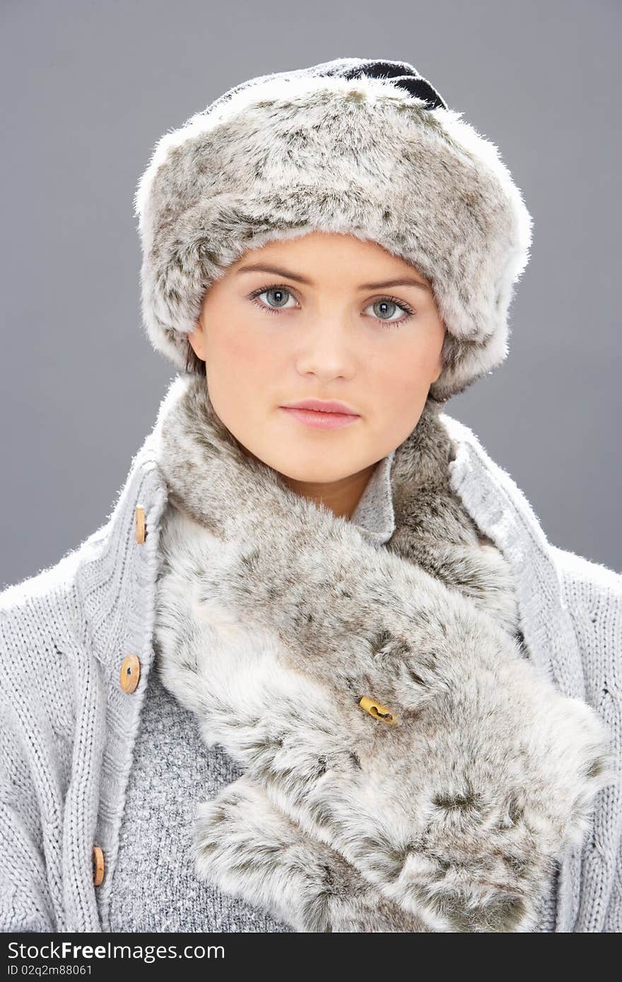 Studio Portrait Of Young Woman Wearing Fur Hat And Wrap