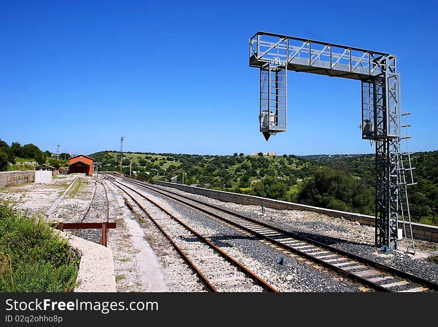 Railway, old station and traffic lights near Donnafugata, in the sicilian countriside. Railway, old station and traffic lights near Donnafugata, in the sicilian countriside