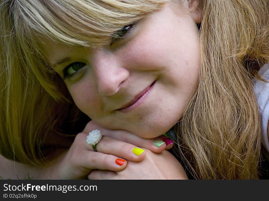 Girl smiling and looking happy on a lawn. Girl smiling and looking happy on a lawn