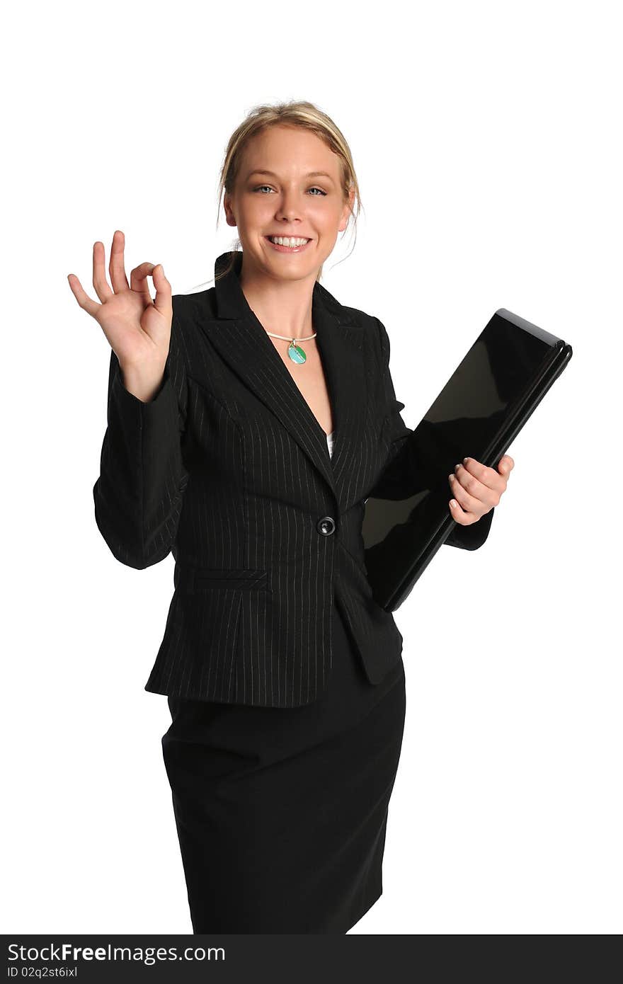 Young businesswoman holding a laptop and with OK sign isolated on a white background