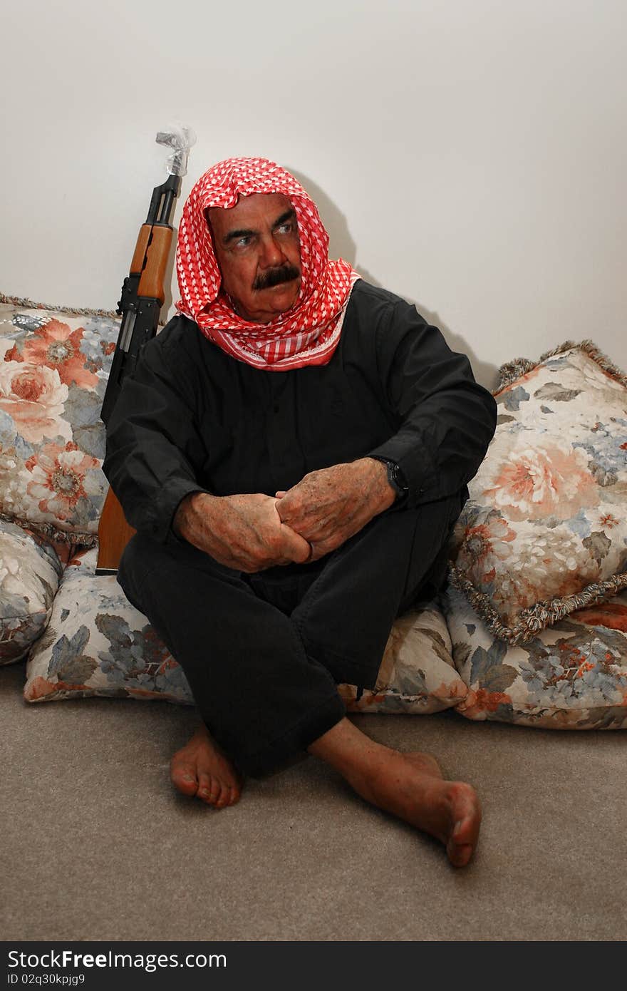 Moroccan  Militia  Man sitting with his AK 47 rifle at home. Moroccan  Militia  Man sitting with his AK 47 rifle at home.