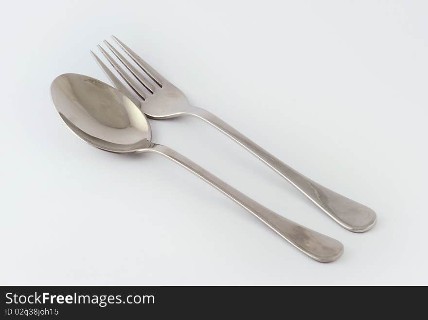 Image of a fork and a spoon over a white background. Image of a fork and a spoon over a white background