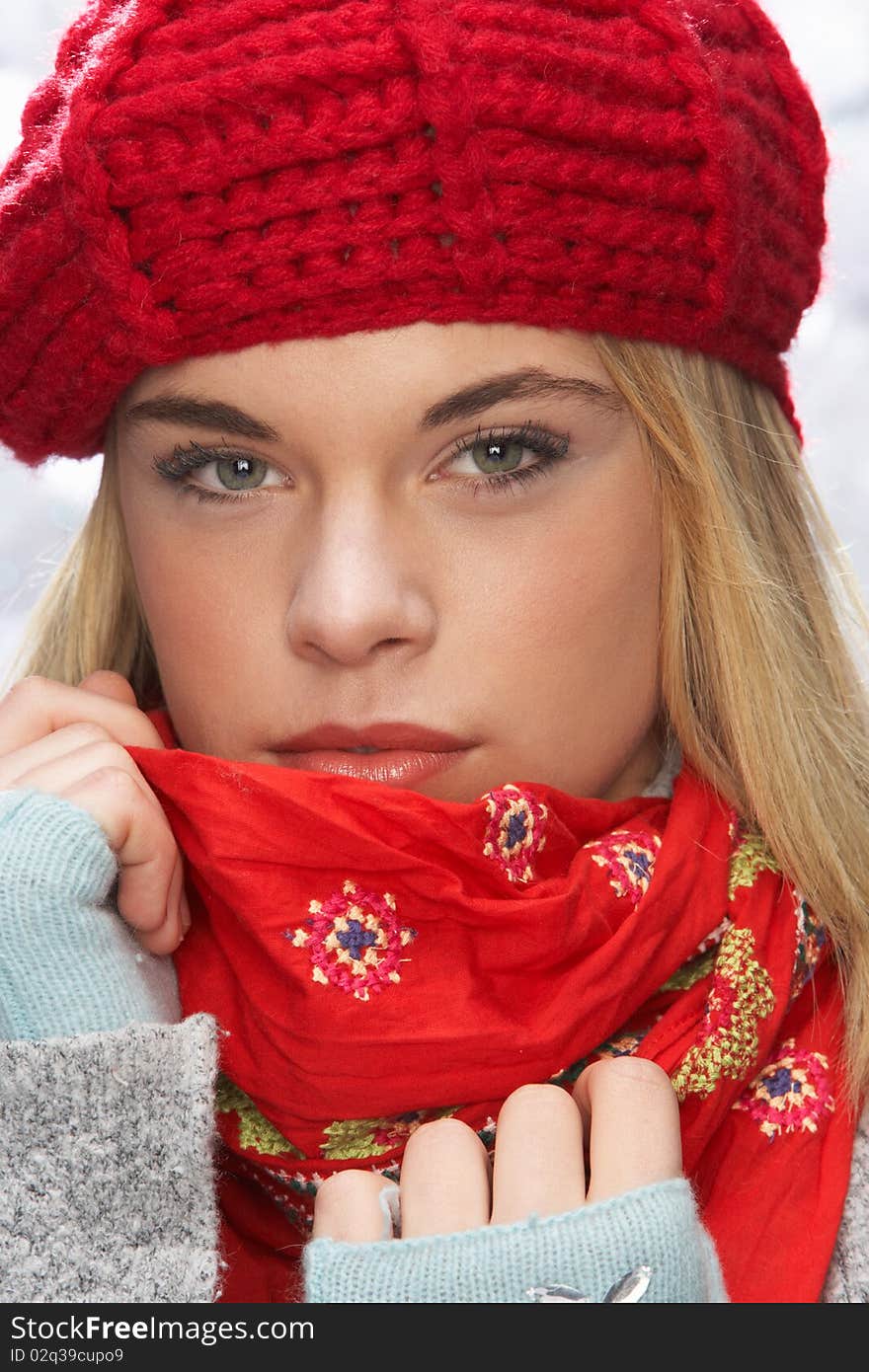 Fashionable Teenage Girl Wearing Cap And Knitwear In Studio In Front Of Christmas Tree