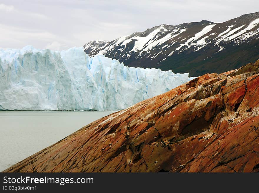 View to the connection of the glacier with nearby mountain. View to the connection of the glacier with nearby mountain