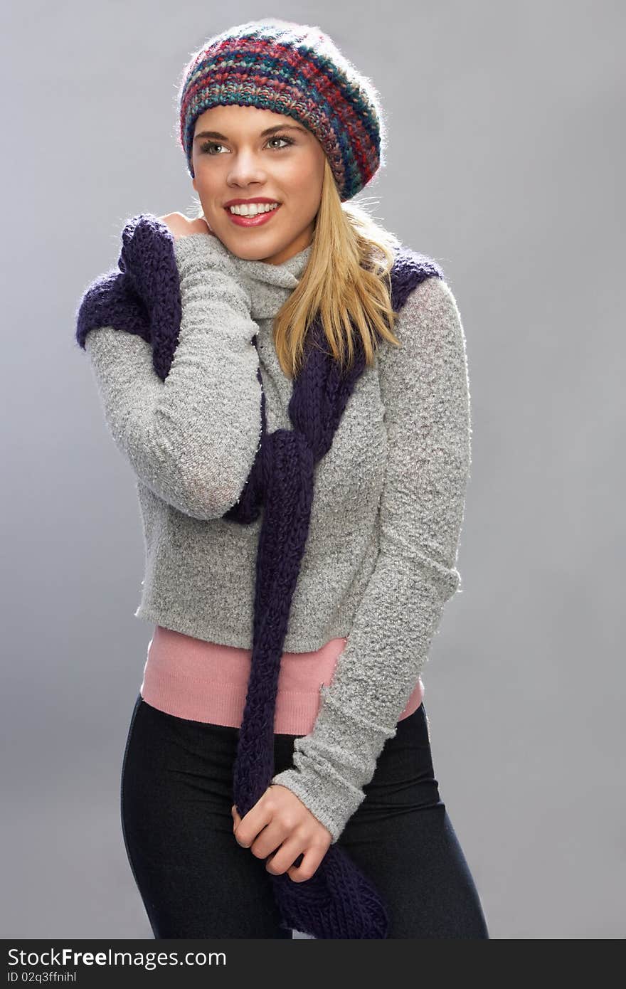 Teenage Girl Wearing Warm Winter Clothes In Studio Smiling