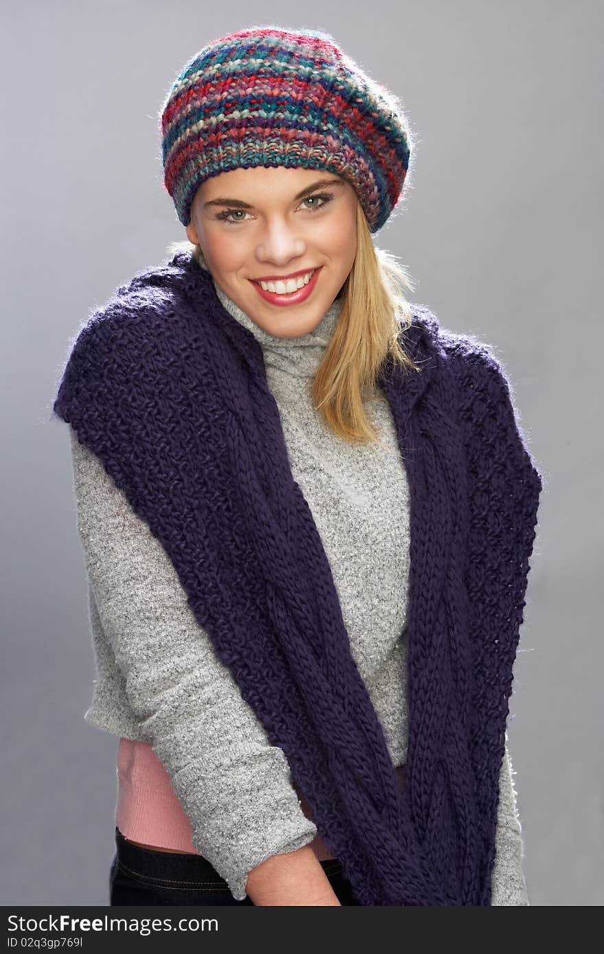 Teenage Girl Wearing Warm Winter Clothes In Studio Smiling