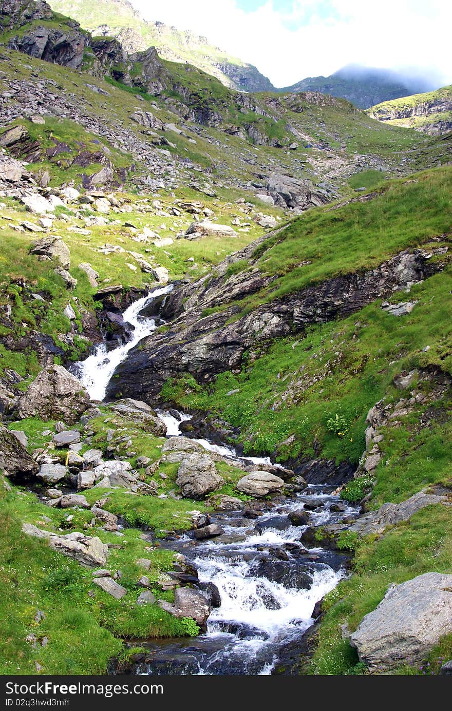 Beautiful landscape with rocky waterfall at high altitude