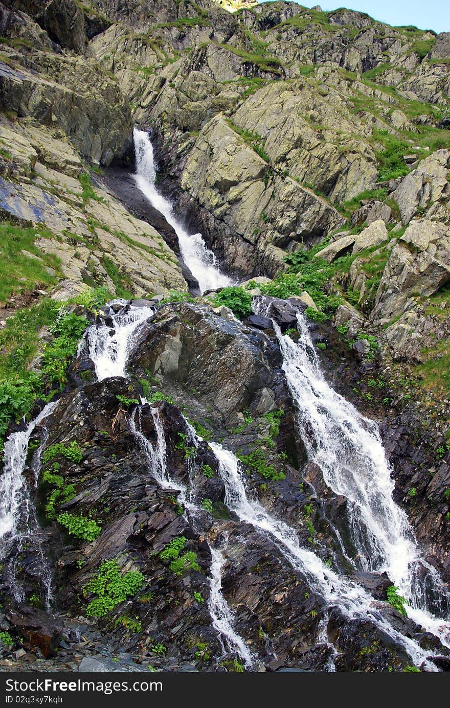 Rocky waterfall on a little river at high altitude