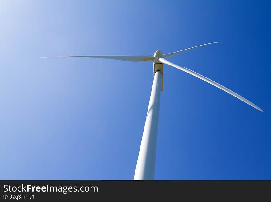 Wind turbine on blue sky