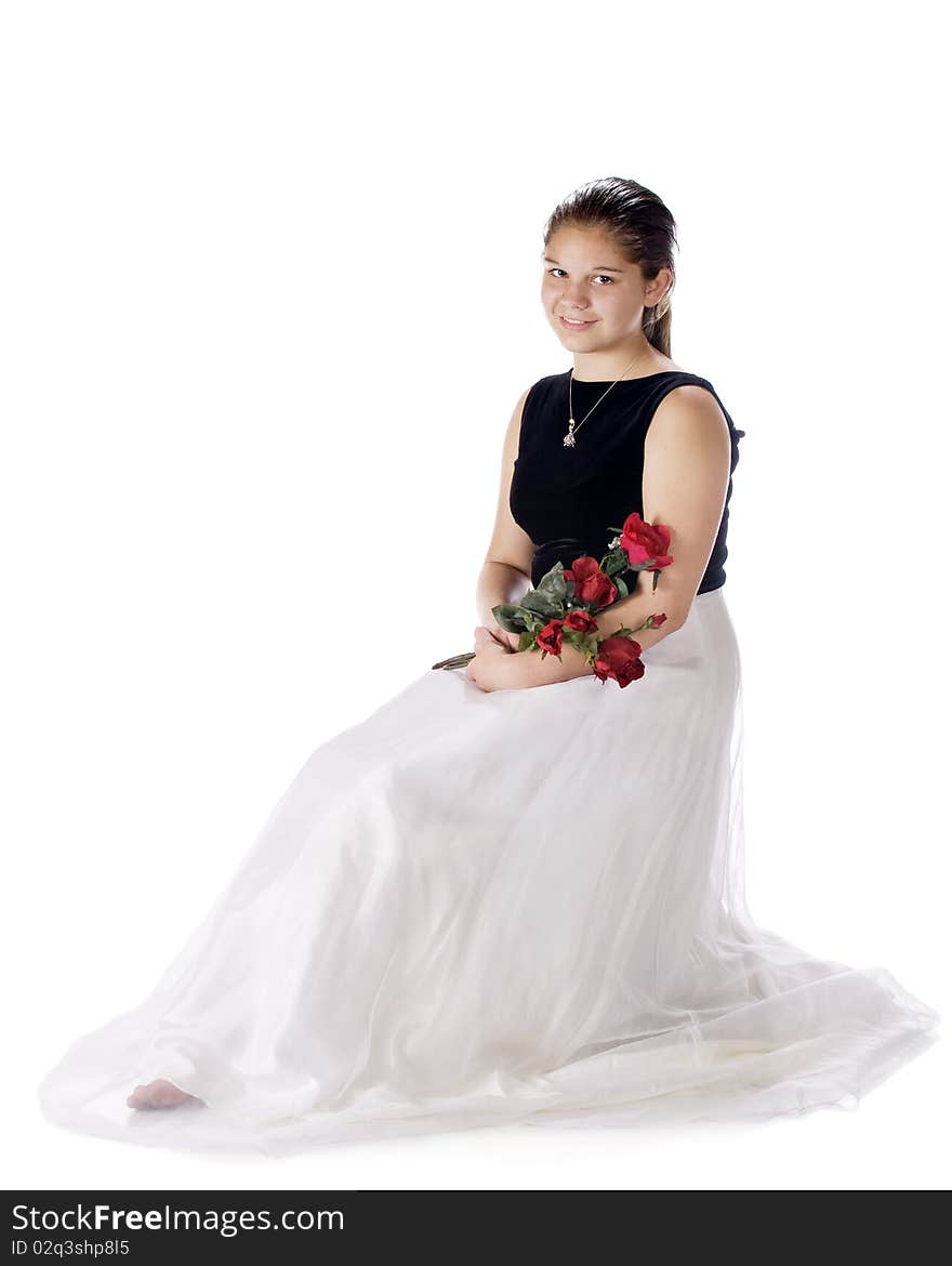 A dressed up young teen sitting with a bouquet of red roses. Isolated on white. A dressed up young teen sitting with a bouquet of red roses. Isolated on white.