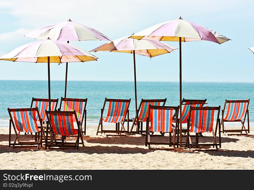 Group of canvas bed and beach umbrellas placing on the Cha-am beach of Thailand. Group of canvas bed and beach umbrellas placing on the Cha-am beach of Thailand