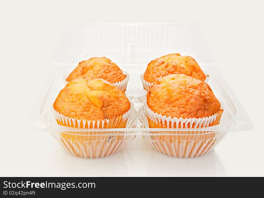 Fresh baked cupcakes in plastic container. Shallow depth of field