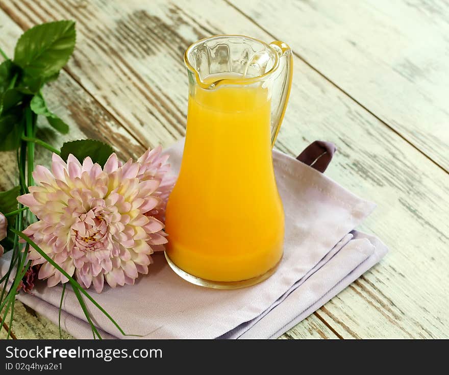 Orange juice in glass on wooden