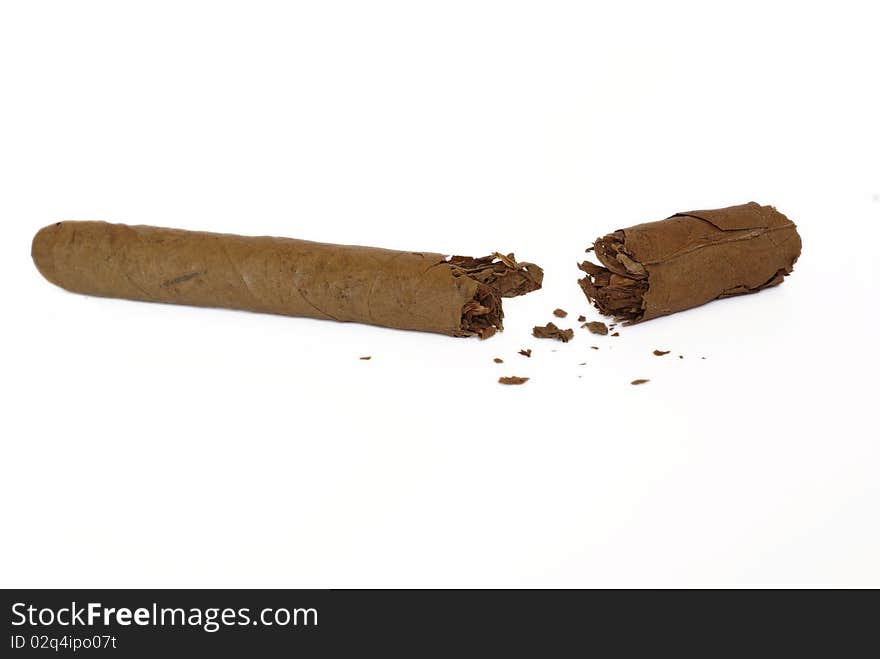 Broken cigar on white background