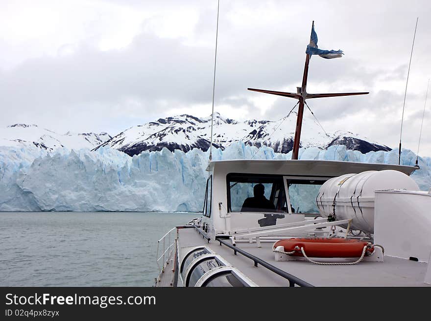 View to the glacier with nearby mountain from a boat. View to the glacier with nearby mountain from a boat