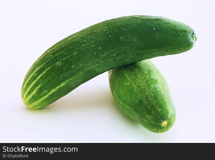 Two green cucumbers on a white background.