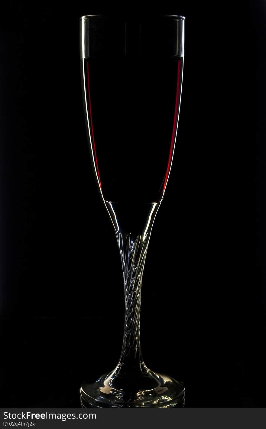 A glass of red wine on black background. A glass of red wine on black background.