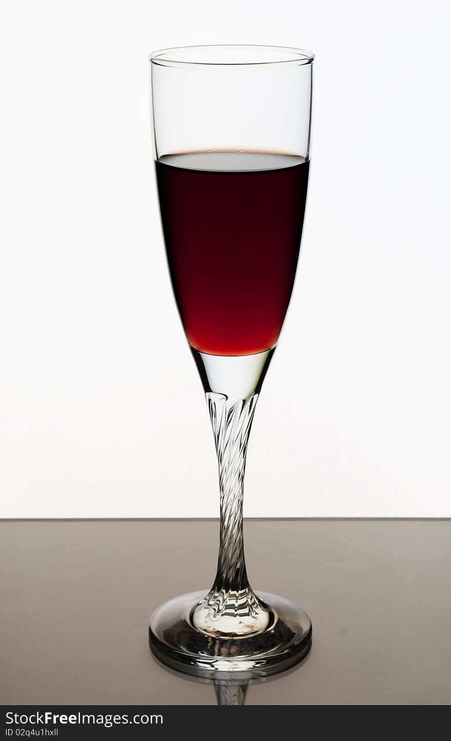 A glass of red wine on a white background. A glass of red wine on a white background.